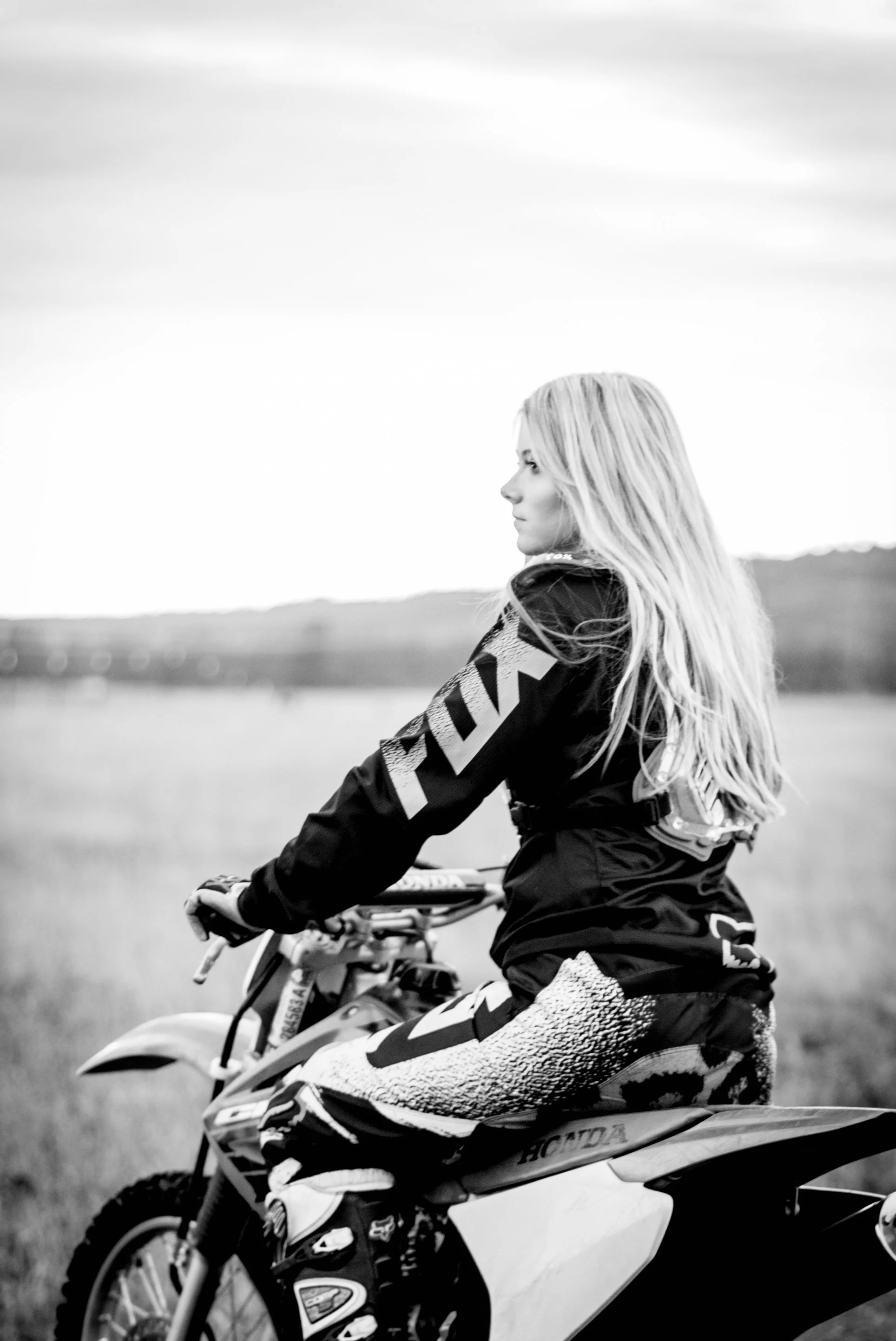 Senior photography session in Coeur d’Alene Idaho with high school senior on dirt bike in open field