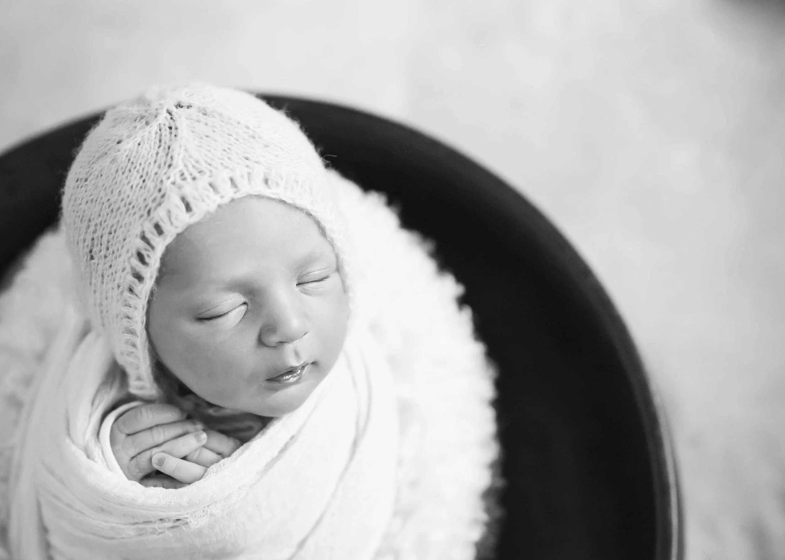Newborn swaddled peacefully sleeping for newborn session in athol idaho