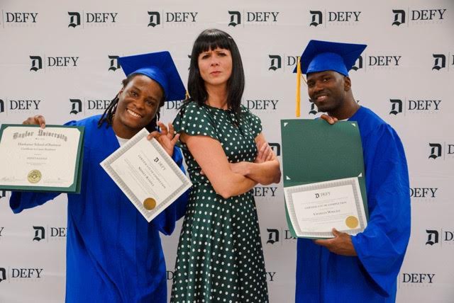 Cat Hoke, founder of Defy Ventures with some of the graduates from the program