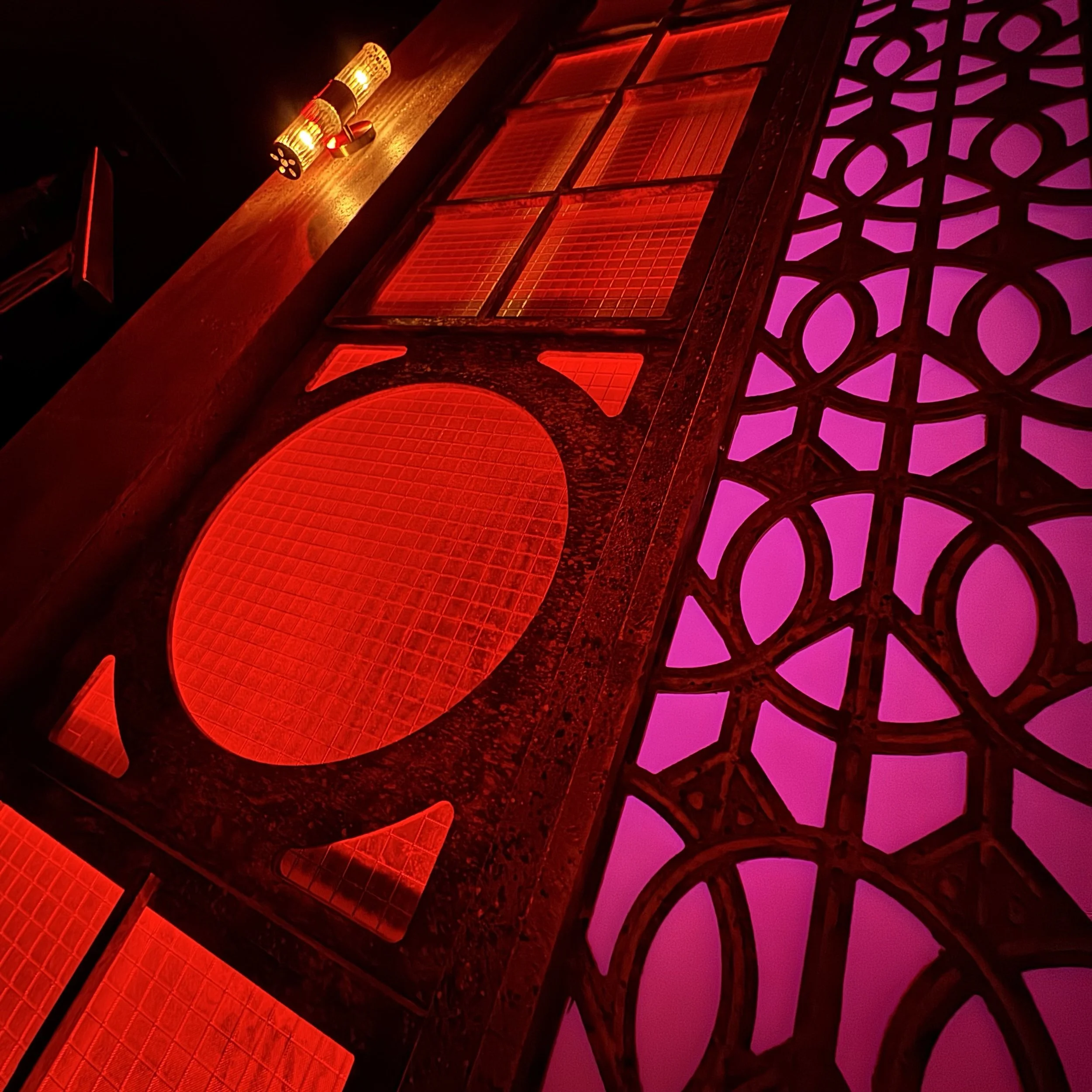 Immersive Cabaret theatre set design featuring a raised central stage, visible onstage band, multi-level platforms, and club-style audience seating surrounding the performance space, designed by Creativesphere.