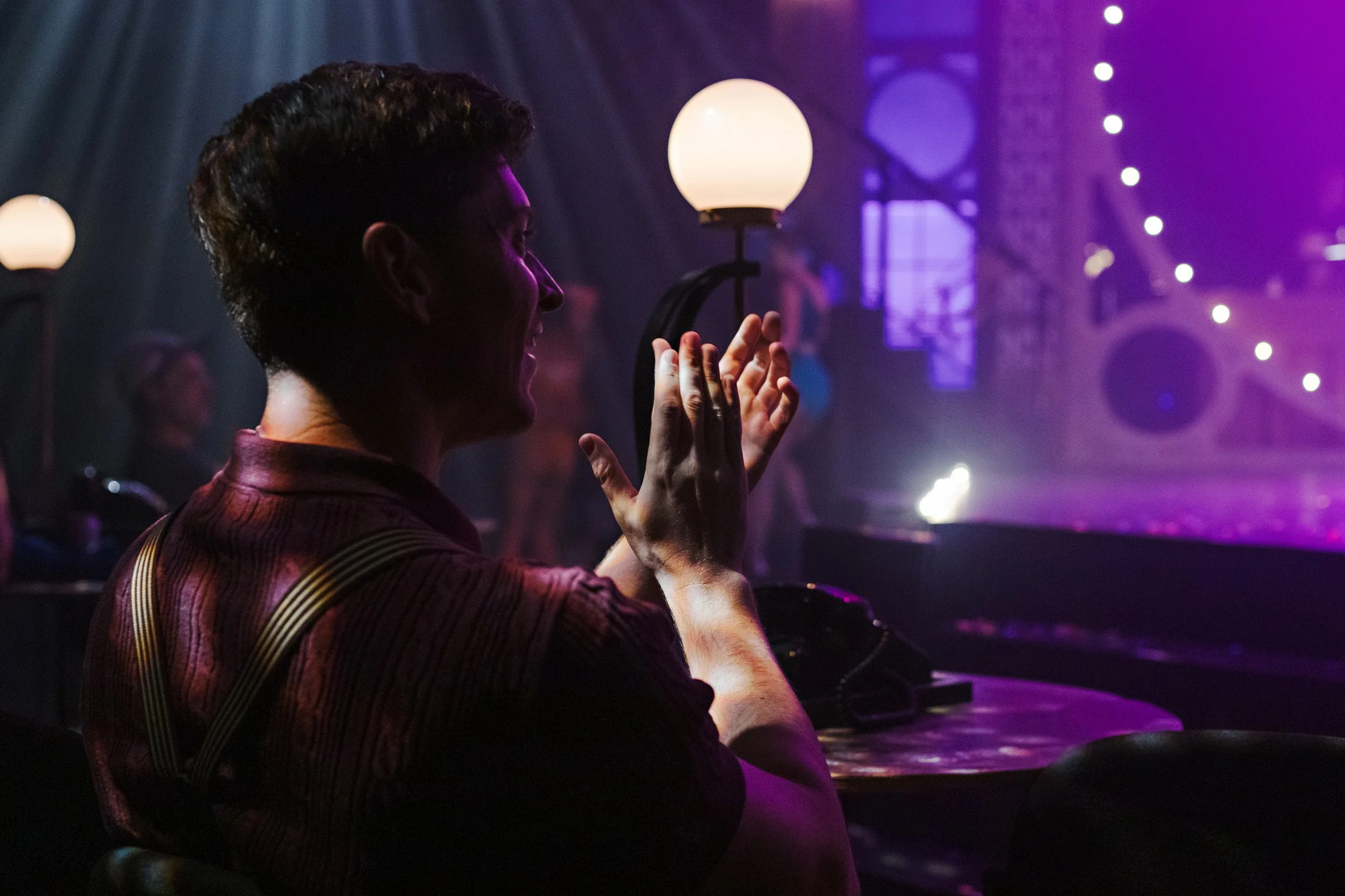 Immersive Cabaret theatre set design featuring a raised central stage, visible onstage band, multi-level platforms, and club-style audience seating surrounding the performance space, designed by Creativesphere.