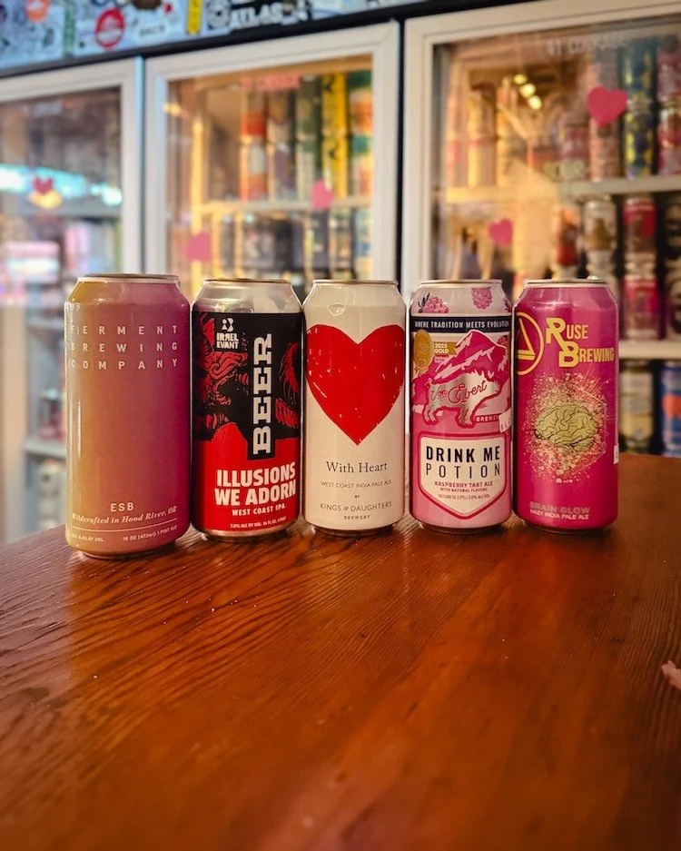 Roses are red.
Beer is cold.
Wine pours nicely.
Stories get told.

Split a bottle over sandwiches at the shop.
Or grab a bottle or a few cans to enjoy at home.

The coolers are stocked. The wine wall is ready.

However you&rsquo;re celebrating, we&rs