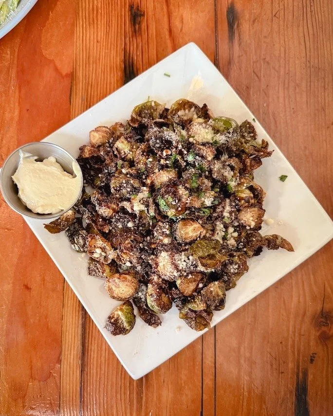 Crispy Brussels + a drink = solid Saturday.

Garlic oil, balsamic, truffle parm, aioli on the side.

We&rsquo;re here 11&ndash;9 today.
Grab a few friends and get a plate to share.
