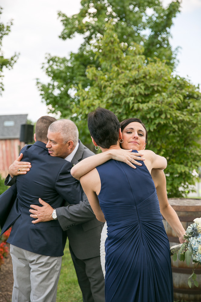 Wedding couple hugging bride’s parents