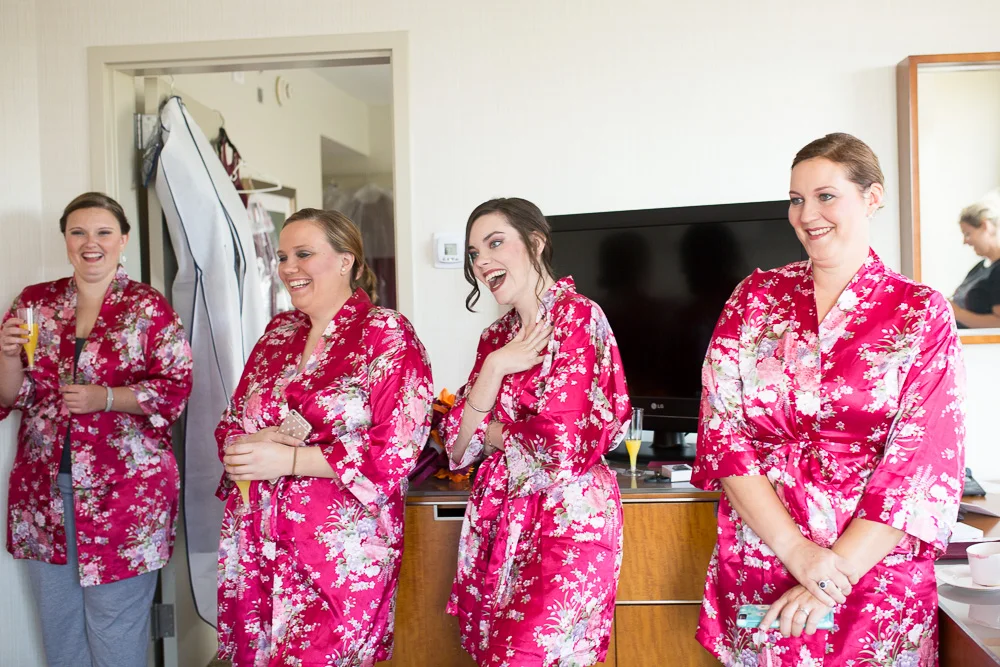Candid laughter photo of the bridesmaids while getting ready for the wedding day | Northern Virginia Candid Wedding Photography