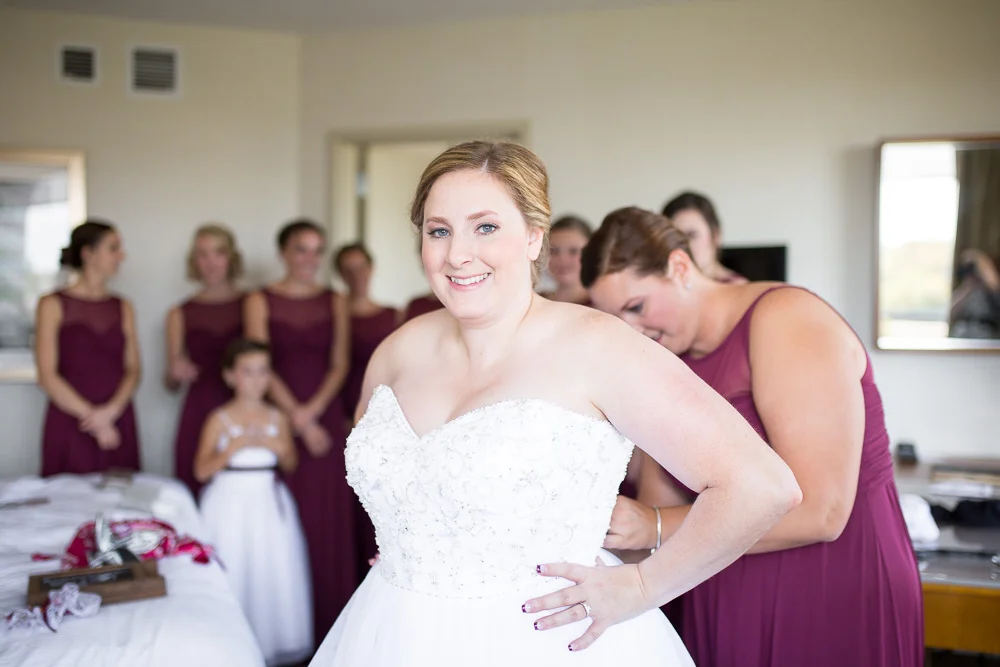 Bride putting on her wedding dress at the Westin Dulles Hotel in Herndon, Virginia | Herndon, Virginia Wedding Photographer