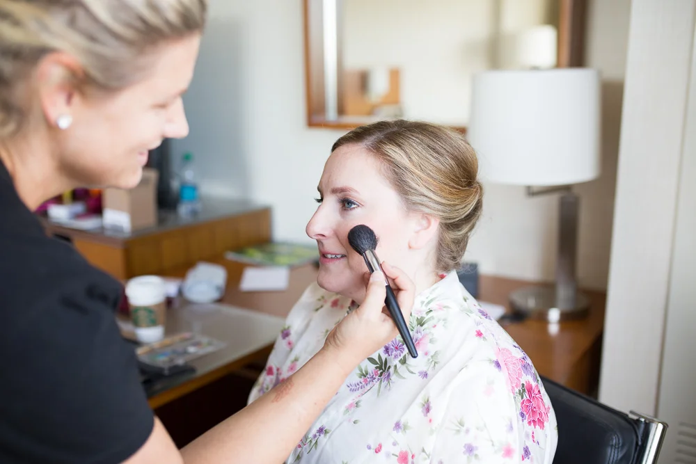 Bride getting ready with makeup done by Makeup by Michelle L | Westin Washington Dulles Hotel Room