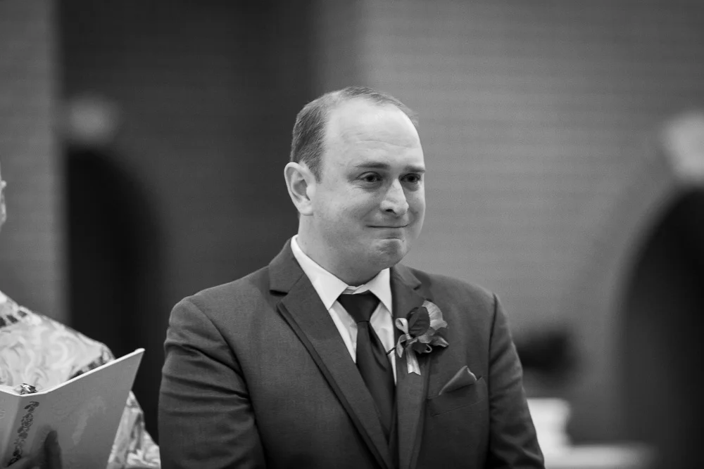 An emotional groom crying as the bride walks down the aisle | St. Theresa Parish Wedding