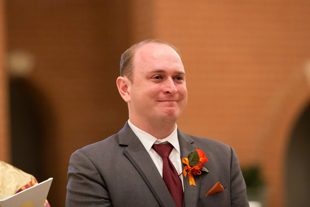 An emotional groom crying as the bride walks down the aisle | St. Theresa Parish Wedding