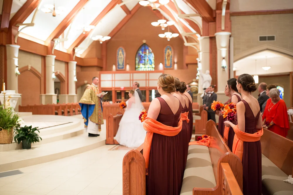 Bridesmaids watching the wedding ceremony at Saint Theresa’s Catholic Church