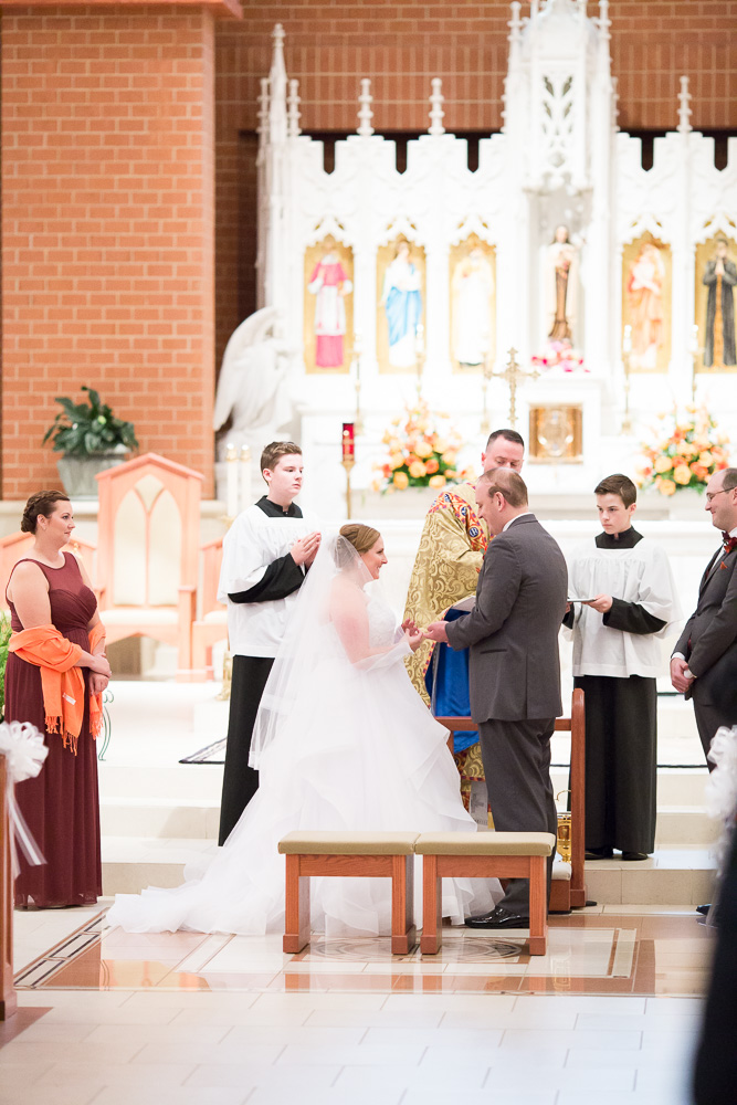 Exchanging rings during the wedding at St. Theresa’s Church | Northern Virginia Wedding Photography