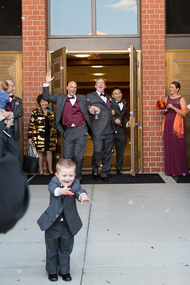 Funny bubble exit photo at St. Theresa Parish in Northern Virginia | Northern Virginia Candid Wedding Photographer