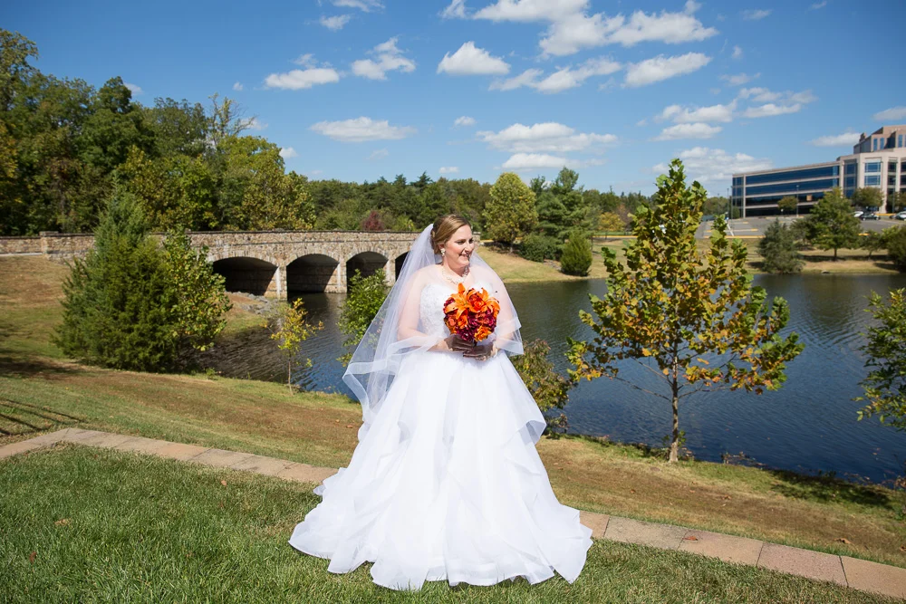 Bride posing in front of the lake at the Westin Washington Dulles in Herndon, Virginia