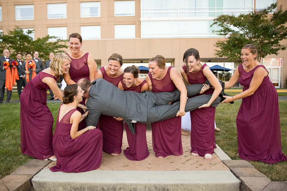 Fun picture of bridesmaids trying to hold the groom | Candid Northern Virginia Photographer | Megan Rei Photography