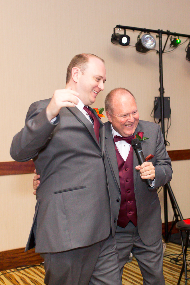 Fun candid moment between the groom and the father of the bride