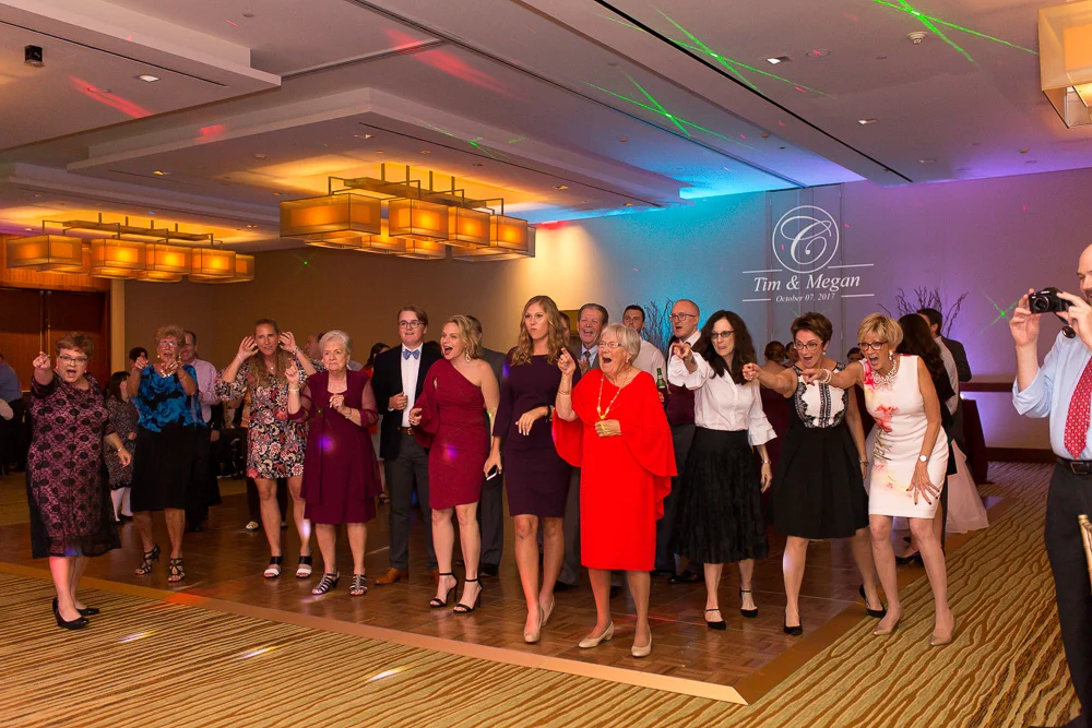 Packed wedding dance floor at the Westin Washington Dulles with colorful uplighting| Best Northern Virginia Wedding Reception Venues