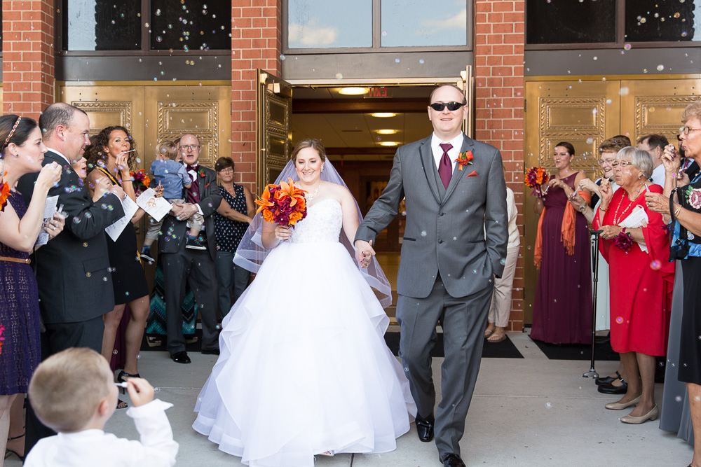 Bride and groom exiting the church with bubbles | Saint Theresa Church Wedding in Ashburn, Virginia