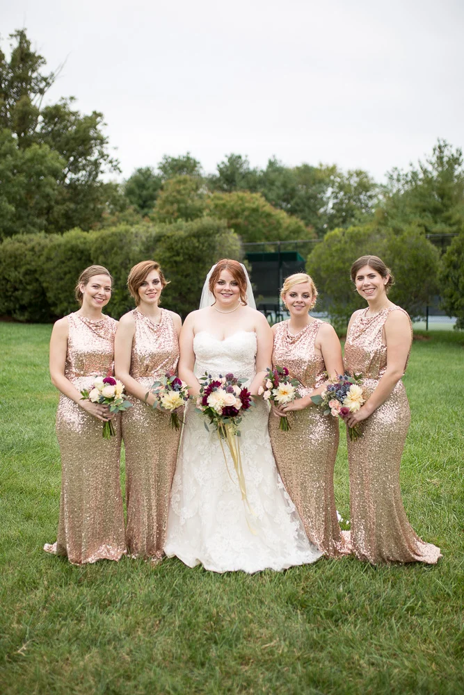 Bride and bridesmaids in rose gold bridesmaid dresses
