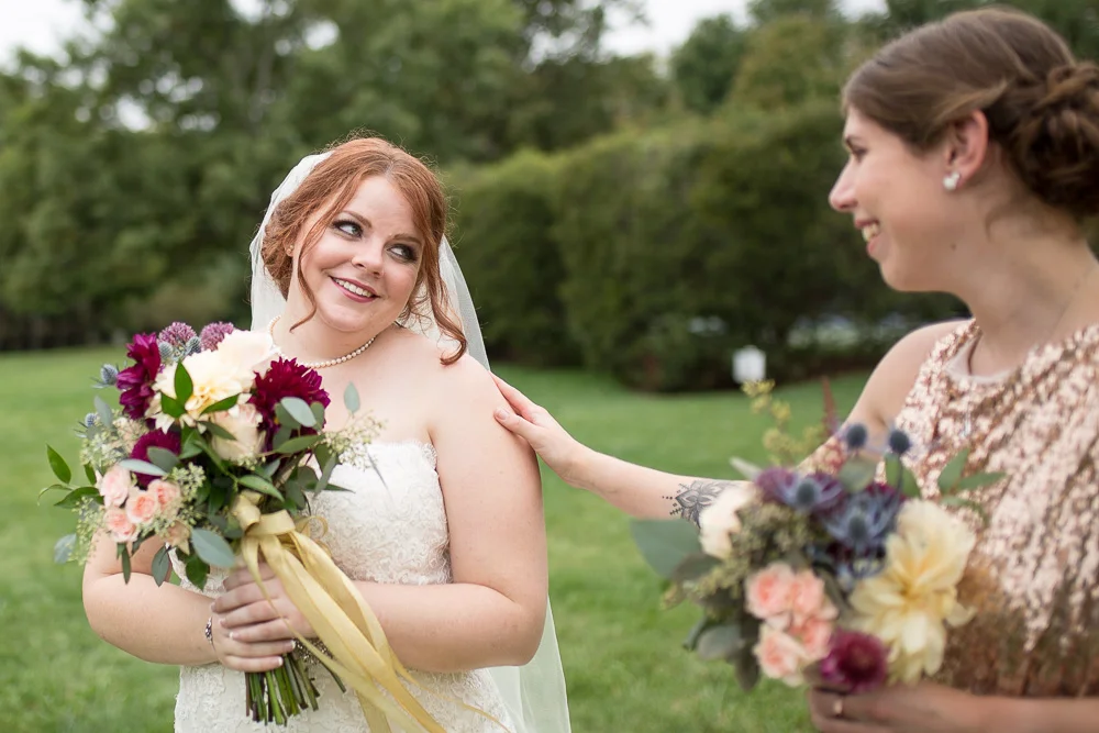 Bride looking over her shoulder at her bridesmaid