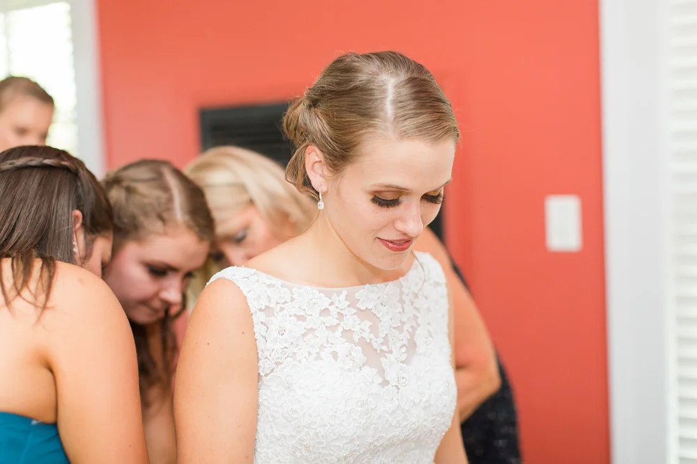 Bride getting her wedding dress zipped up | Candid Wedding Photographer in Northern Virginia