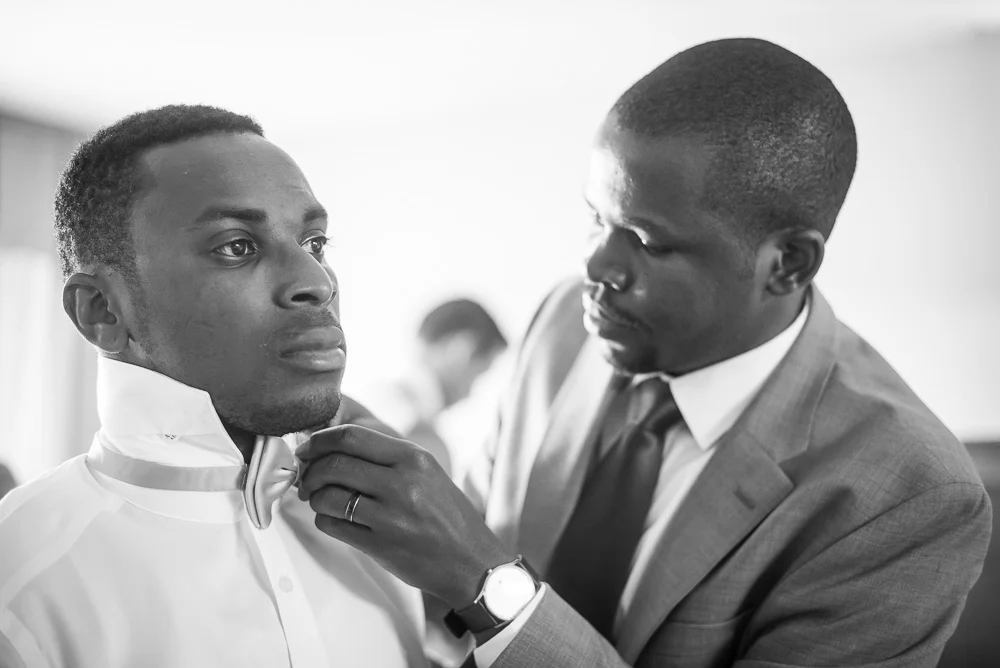 Groomsmen helping the groom with his bow tie in Culpeper, Virginia
