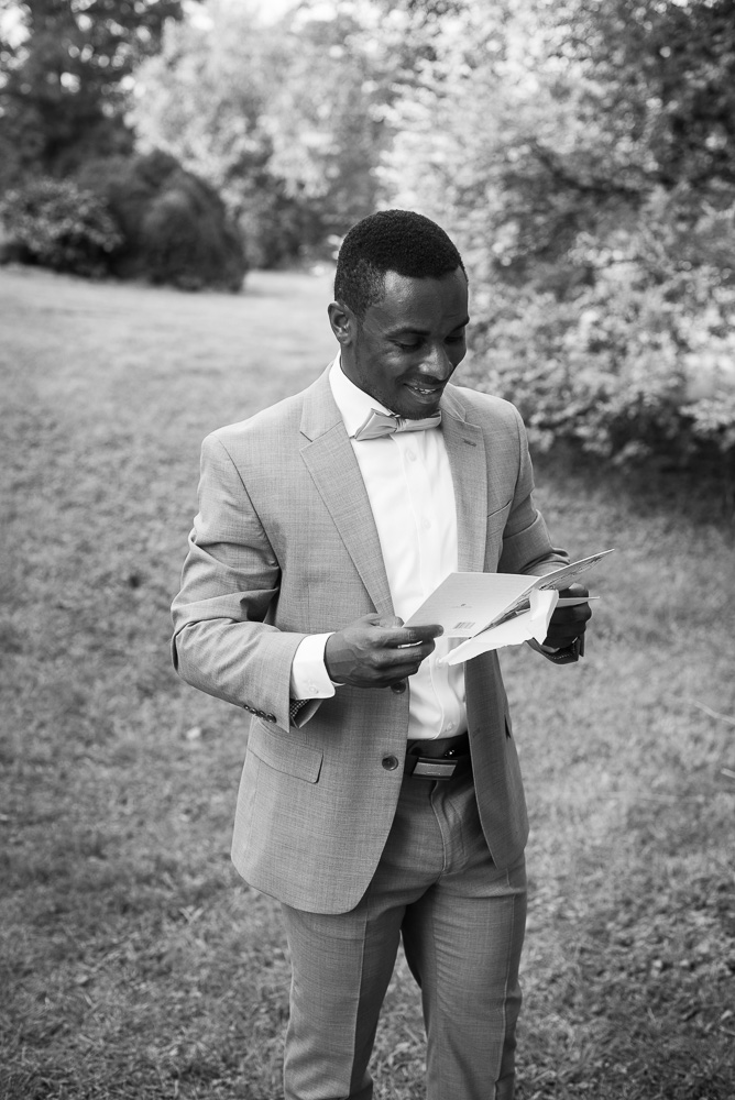 Groom opening a letter from the bride before the wedding ceremony