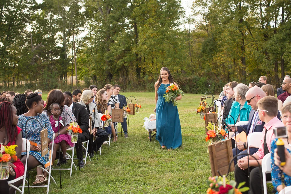 Bridesmaid walking down the aisle with Cody, the Dog of Honor, in tow | Culpeper, Virginia Wedding