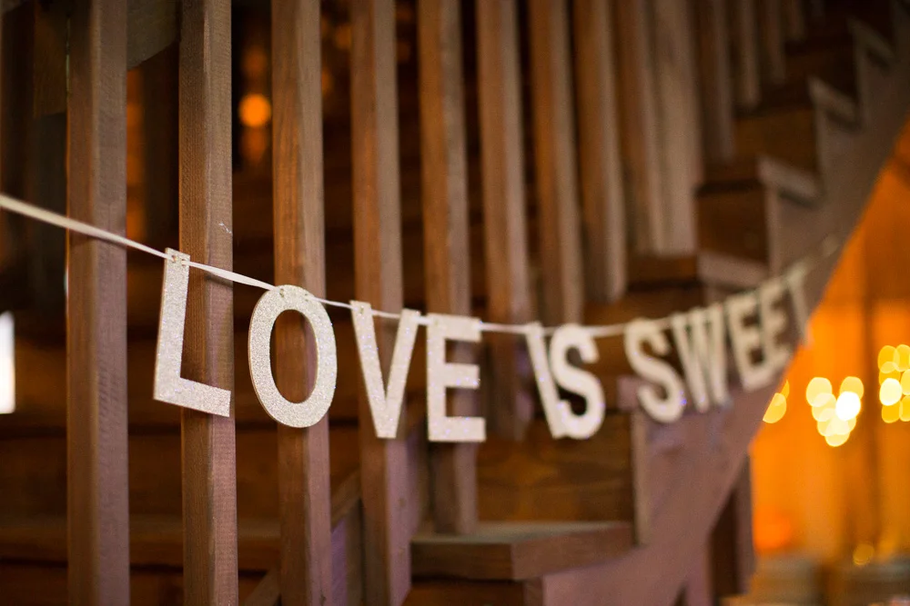 "Love is sweet" sign for dessert table at Mountain Run Winery | Barn wedding venues in Culpeper, Virginia