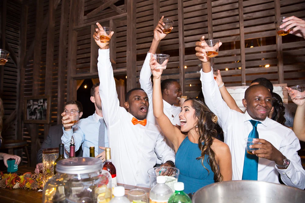 Taking shots at the bar at Mountain Run Winery | Best Barn Wedding Venues in Culpeper, Virginia | Candid Culpeper Photographer