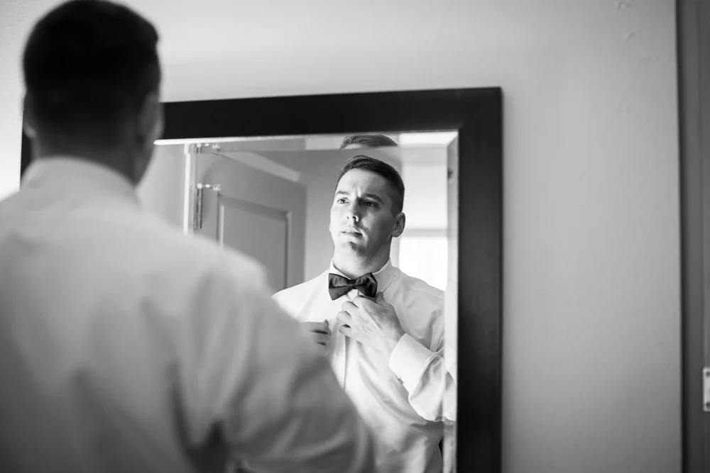 Groom straightening his tie | Documentary Rochester NY Wedding Photography