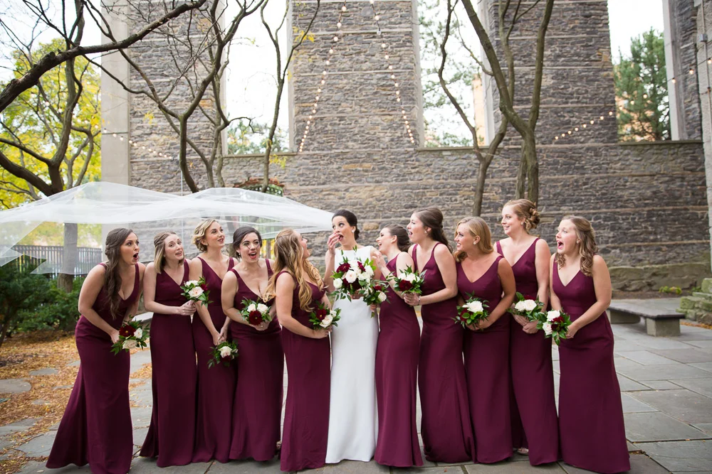 Funny wedding photo of veil caught in the wind | Candid Wedding Photographer in Rochester NY | Megan Rei Photography | St. Joseph’s Park