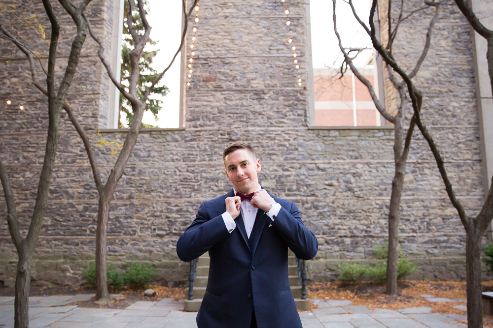 Groom straightening his tie
