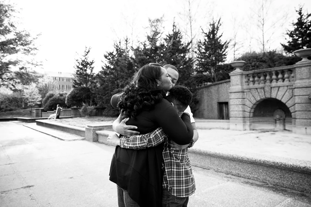 A sweet family hug in front of the Meridian Hill fountain | Washington, DC Documentary Photographer