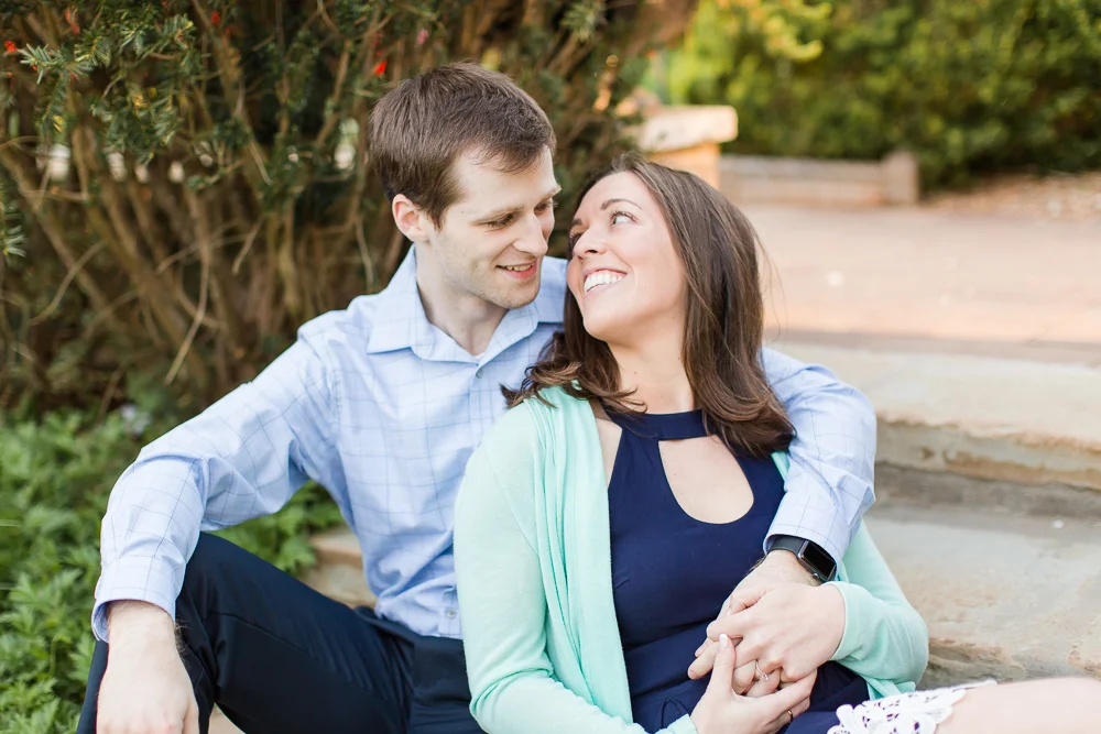 Sweet photo of engaged couple sitting on the garden steps | Candid Engagement Photography