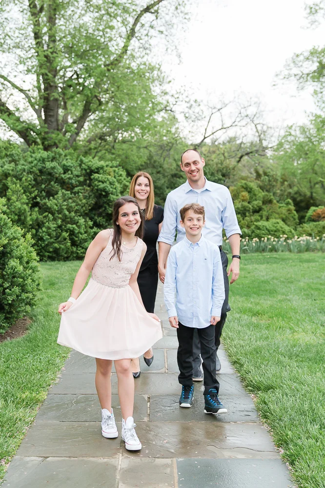 Family photo walking down the walkway in front of the Glenview Mansion in Rockville, MD | Rockville Photographer