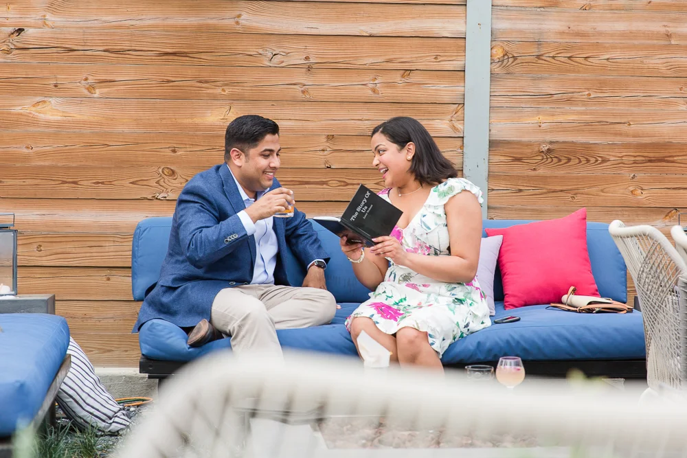 Reading “The Story of Us” book that Vedant designed to tell their love story | Masseria DC Proposal Photos | Megan Rei Photography