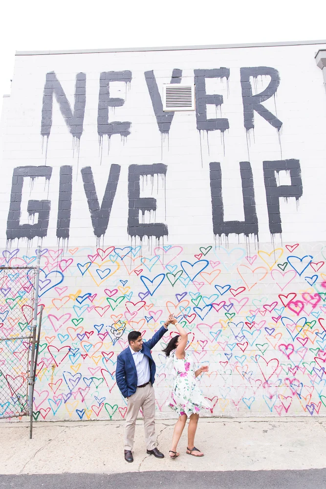 Dancing by the Never Give Up mural and heart wall | Heart Wall Engagement