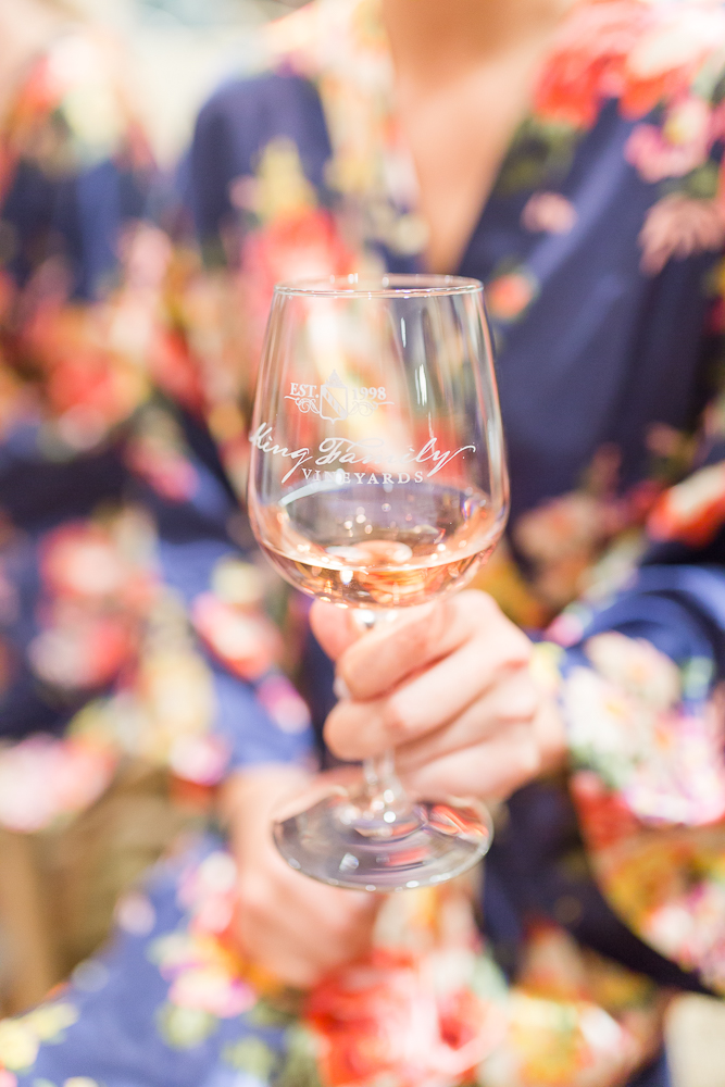Bridesmaid holding a glass of King Family Vineyards wine