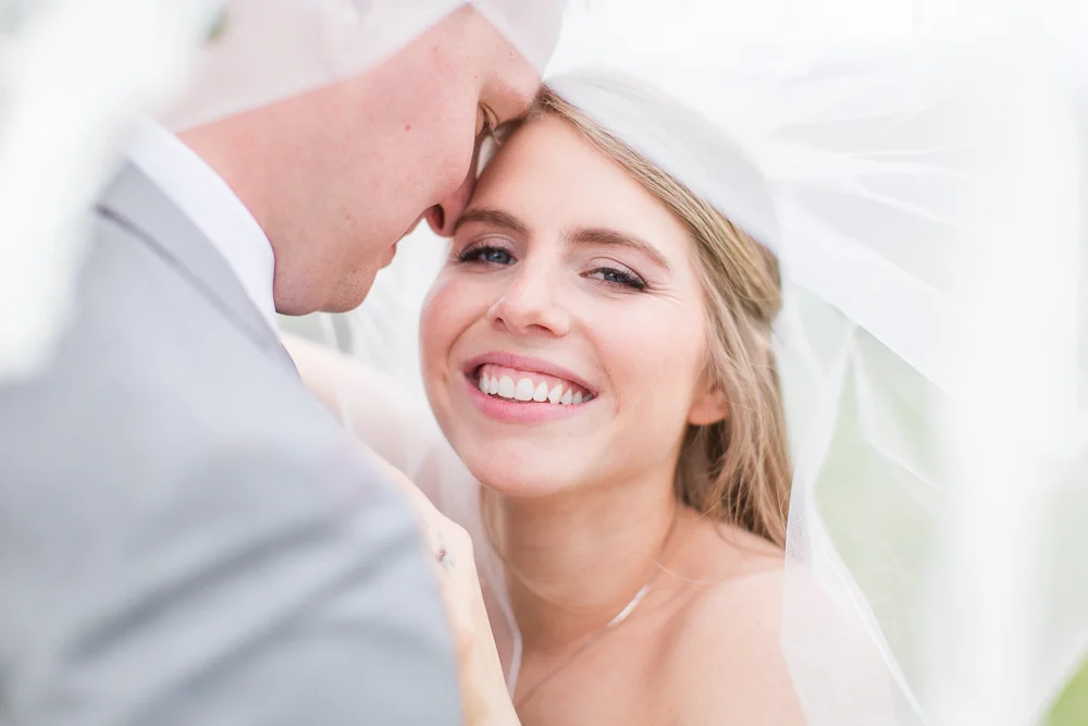 Beautiful candid photo of bride under her veil | Crozet Wedding Photographer