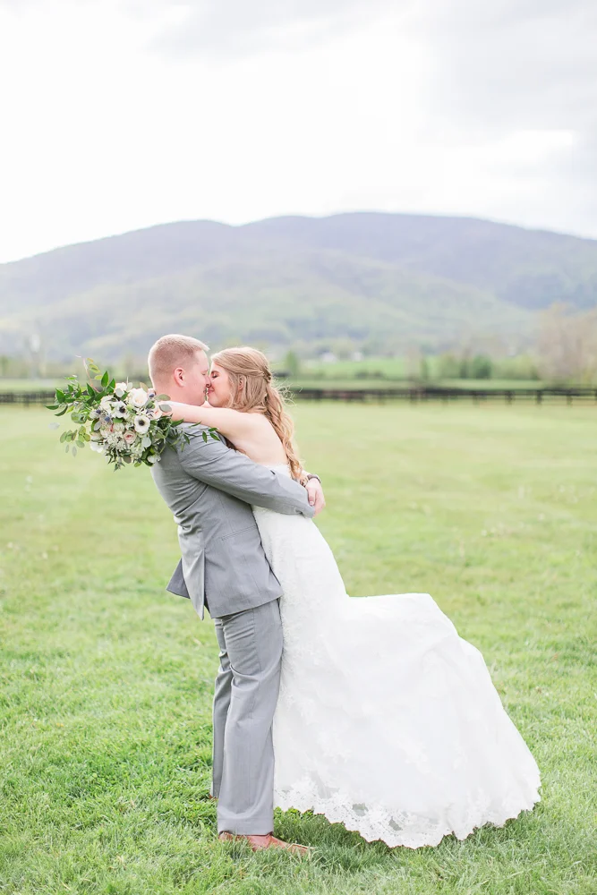 Groom lifting the bride for a kiss