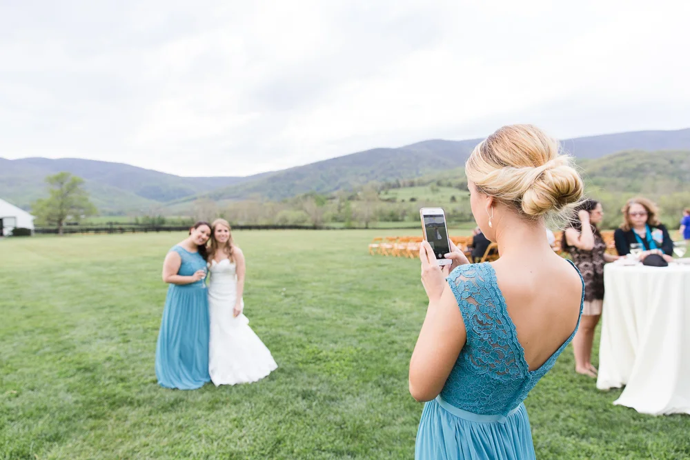 Bridesmaids taking pictures during cocktail hour