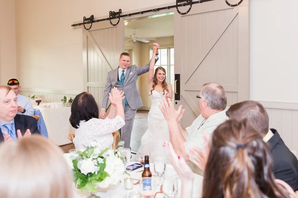 Bride and groom grand entrance into the wedding reception at King Family Vineyards Carriage House | Crozet, Virginia Wedding Photographer
