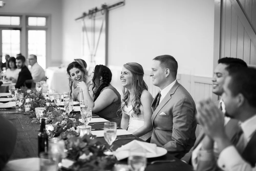 Candid wedding reception picture of bride laughing during the toasts | Charlottesville Virginia Wedding Photographer