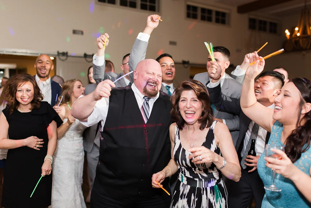 Wedding guests having fun on the dance floor at King Family Vineyards | Candid dancing photos in Crozet, Virginia