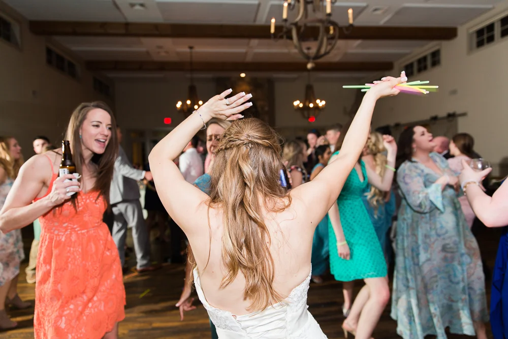 Bride dancing with glow sticks at her wedding reception at King Family Vineyards