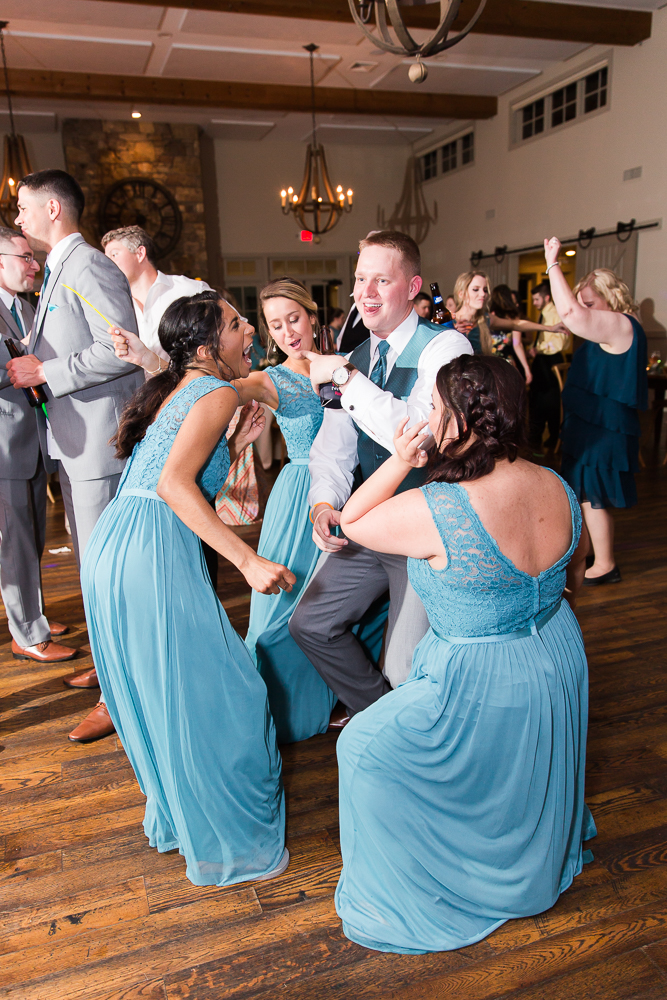 Groom dancing with the bridesmaids during the wedding reception in Crozet, Virginia