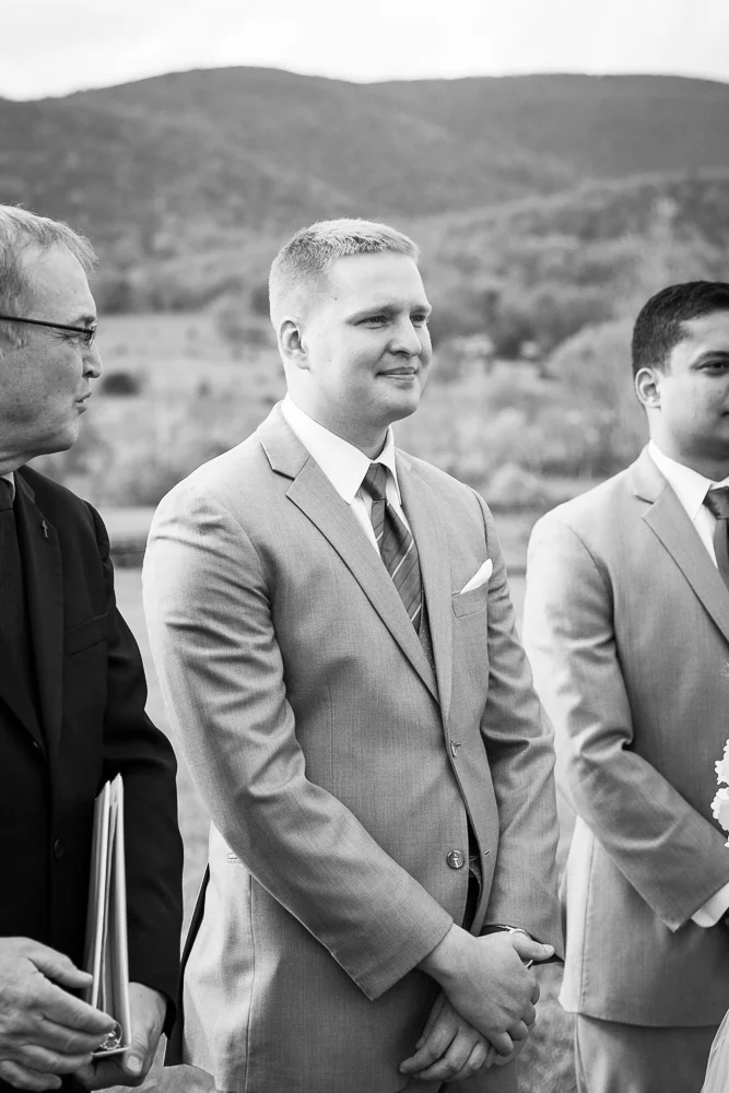 Groom watching his bride walk down the aisle at King Family Vineyards wedding venue in Crozet