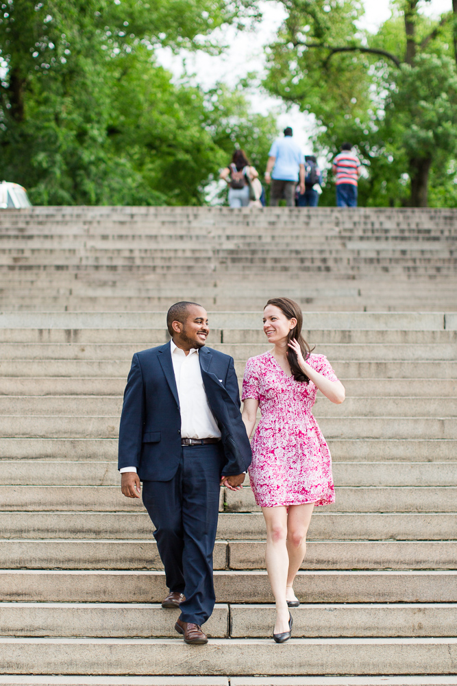 Walking down the big staircase at the Bethesda Terrace during a Central Park engagement session | Best NYC Engagement Picture Locations