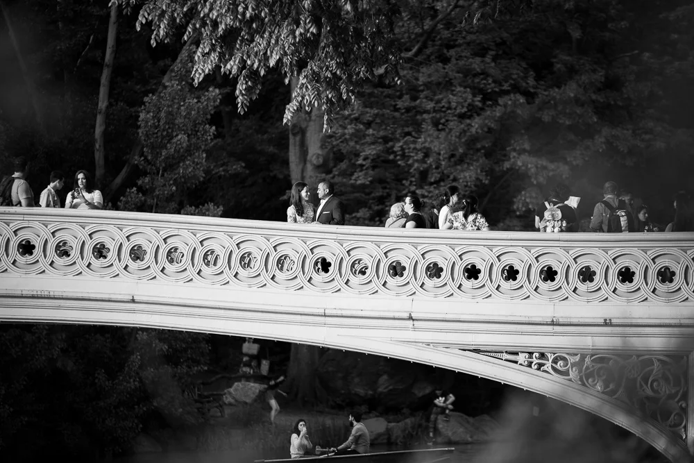 Engaged couple on the Bow Bridge in Central Park