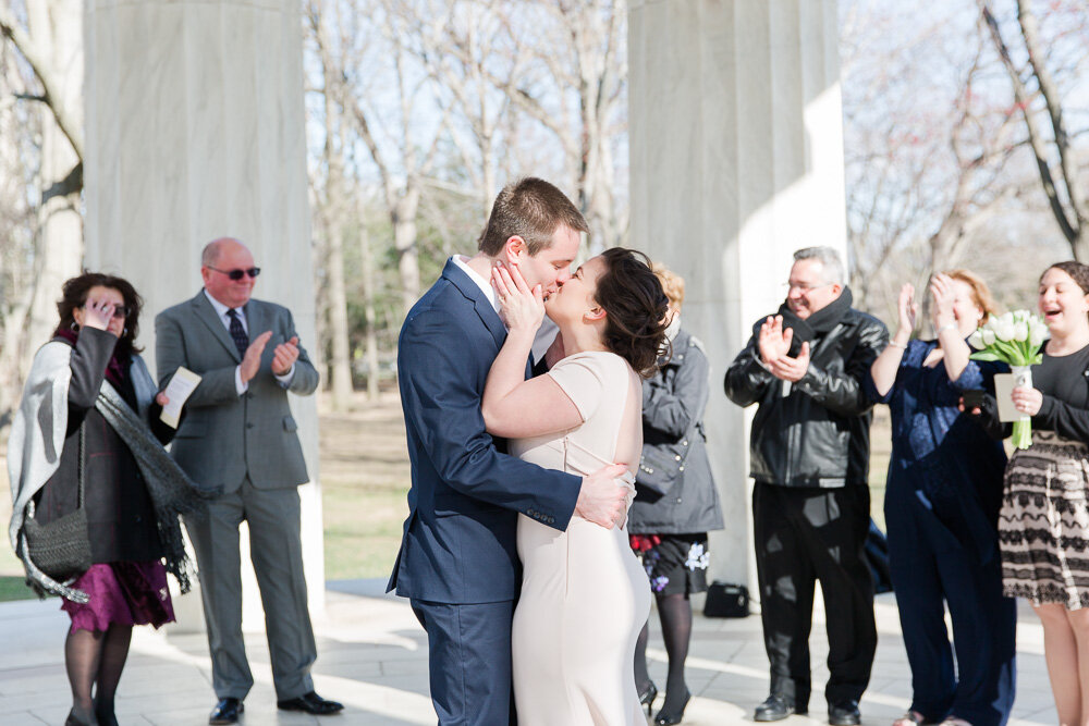 Bride and groom kiss in small ceremony